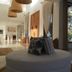 Kala Hotel Boutique in Maldonado lobby with round daybed, striped chairs, and large windows