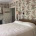 Spread Eagle Tavern and Inn in Hanoverton guest room with floral wallpaper, fireplace and bed