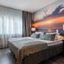 Original Sokos Hotel Kaarle, Kokkola: guest room with double bed and sunset wall mural