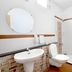Hotel De Ecobiz Ahmedabad bathroom with pedestal sink, toilet and shower curtain
