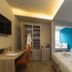 Ddream Hotel in St. Julian's guest room with king bed, desk, wardrobe and blue accent wall