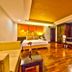 The Heritage Sathorn Suite Hotel Bangkok suite with bed, seating area and kitchenette
