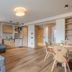 Hotel Bellavista in Cavalese: bright suite with sofa, kitchenette, dining table and wood flooring