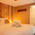 The Wiremill in Lingfield: cozy wood-paneled hotel bedroom with a neatly made double bed