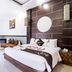 Fullmoon Villa Ubud, Ubud: bright villa room with king bed, sitting area and modern tiled accent wall