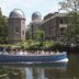 Golden Tulip Leiden Centre in Leiden, canal boat passing observatory domes and riverside buildings