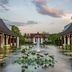 JW Marriott Khao Lak Resort & Spa in Takua Pa with a lagoon pool, water lilies, and sunset sky