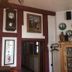 Hotel Vier Jahreszeiten in Volkach: traditional lounge with wall clock, framed art, and wooden display cabinet