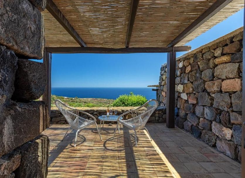 Pantelleria Dream Resort in Pantelleria terrace with chairs and table overlooking the sea