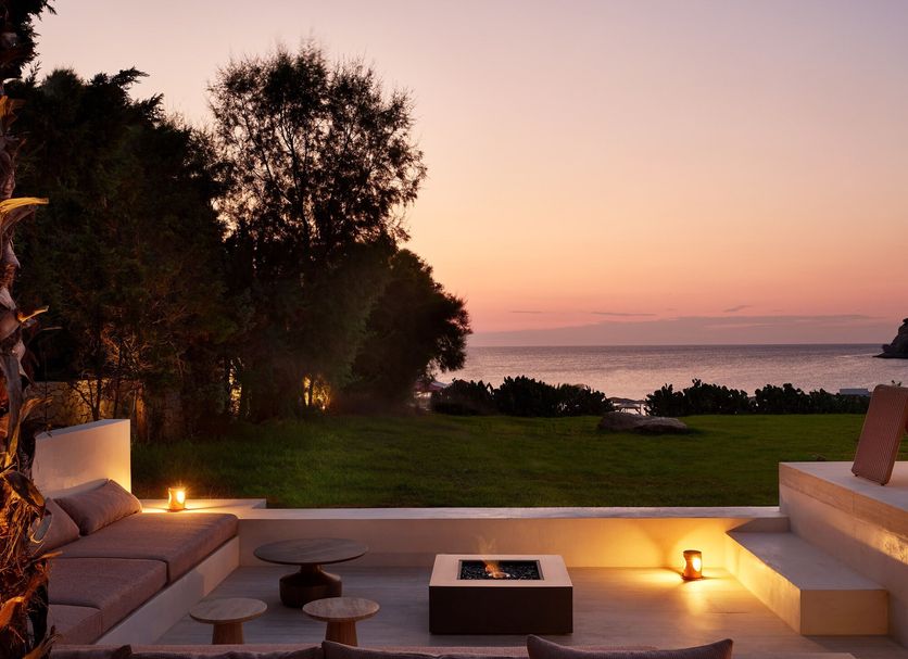 Hotel Sentido Port Royal Villas & Spa in Kolympia: sunset terrace with sea view and glowing lounge seating