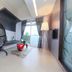 The House of Water in Dongshan Township: modern room with hanging chair, floor lamp, and window view