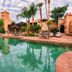 Ksar Ighnda in Aït Ben Haddou with a courtyard pool, palm trees and lounge chairs