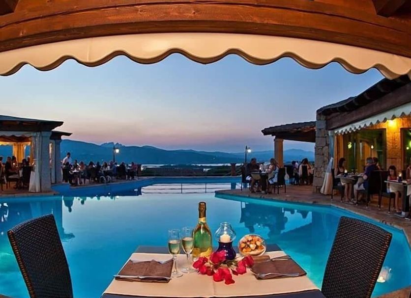 Residence Stella di Gallura in Porto Rotondo, poolside dining with sunset sea view