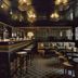 Château Voltaire Paris bar lounge with stools, sofas and moody dark ceiling lighting