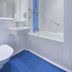 Travelodge Hull Central bathroom with bathtub shower, sink, toilet and blue floor in Hull