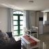 La Venecia de Canarias Puerto de Mogan living area with sofa, table, kitchenette and glass doors in Mogán