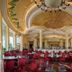 Guangzhou Phoenix City Hotel in Guangzhou dining hall with ornate ceiling, chandeliers and red chairs