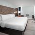 Wingate by Wyndham Sheboygan guest room with king bed, desk, chair and wall-mounted TV