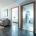 The Preston House and Hotel in Riverhead: bright suite with sofa, chairs, bedroom, and adjoining bathroom