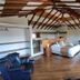 Casa de Campo Hotel & Spa in Villa de Leyva: rustic suite with wood-beam ceiling, king bed, and leather seating