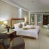 Gentl Grown Sanya Seashore room in Sanya with king bed, desk, TV, chair and balcony doors