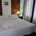 La Teresita Hotel Boutique in Salta features a cozy bed with bedside lamps and brick accent walls.