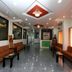 Sai Sangam Hotel Shirdi lobby with benches, tables, glossy floor and ceiling lights