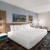 La Quinta Inn & Suites by Wyndham Atlanta Roswell guest room with king bed, desk, and window seating