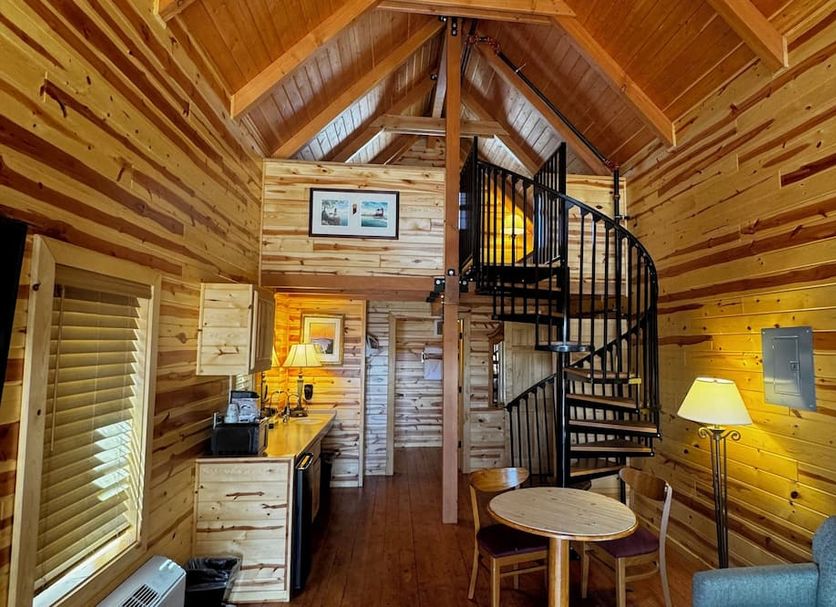 Cabins of Mackinaw in Mackinaw City cabin interior with spiral staircase and loft
