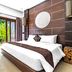 Fullmoon Villa Ubud in Ubud guest room with sliding doors to a tropical patio
