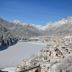 Hotel Centrale in Auronzo di Cadore with snowy village and frozen lake mountain view