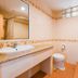 Aa Pattaya Ville bathroom in Pattaya with sink, toilet, mirror, and tiled walls