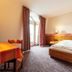 enjoyHotel garni Korntal Stuttgart guest room with single bed, desk and balcony door in Korntal-Münchingen