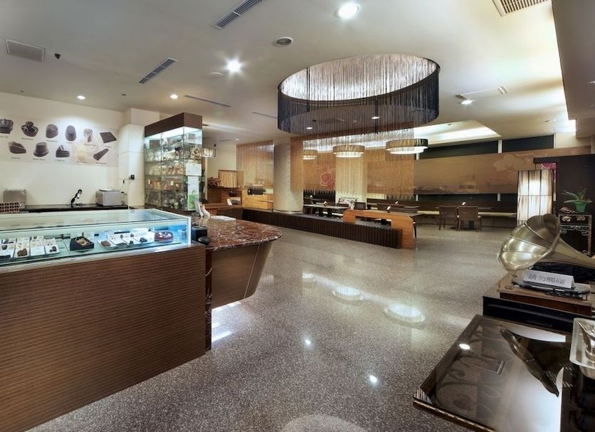 Sun Moon Lake Karuizawa Villa B&B lobby with reception desk and display cases in Yuchi Township