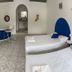 Hotel Paraiso Kora in San Blas room with two beds, round table, arched doorway and wall art