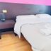 L'Affittacamere di Venezia in Venice guest room with double bed, bedside table and white linens