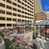 Moxy Cincinnati Downtown rooftop terrace with glass-enclosed seating and city skyline views