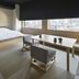Onsen Ryokan Yuen Shinjuku in Tokyo guest room with low bed, seating area and city view