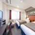 Hotel Mystays Sakaisuji Honmachi in Osaka guest room with two twin beds, TV, and window seating