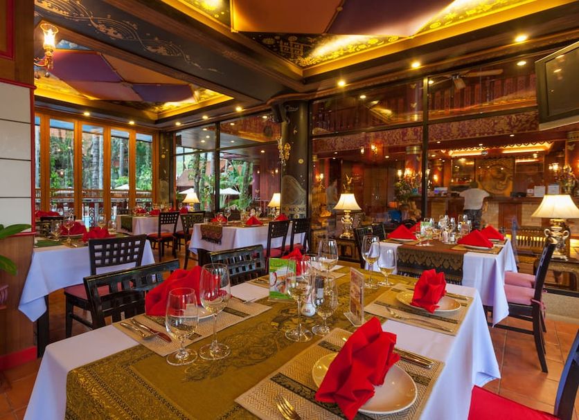 Royal Phawadee Village Patong restaurant with set dining tables and warm interior lighting