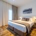 The Grosvenor in Timaru guest room with king bed, sheer curtains and wall art