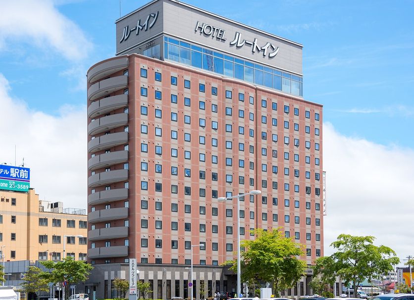 Route Inn Grantia Hakodate Ekimae hotel exterior in Hakodate, a tall pink-and-gray building