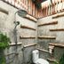 Songphuamia Guesthouse in Chiang Khan bathroom with open-air shower, toilet, and potted plants