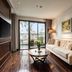 Anatole Hotel Hanoi suite with balcony, sofa, and wood floors in Hanoi