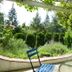 Albergo Giardino in Balatongyörök with blue benches under a garden pergola and lush greenery