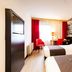Bastion Hotel Dordrecht Papendrecht room with twin beds and red chairs in Dordrecht