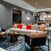 Hilton Garden Inn Chandler Downtown lobby lounge with sectional seating, patterned rug, and TV