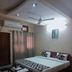 Goroomgo Mourya Inn Madhya Pradesh room in Harda with double bed, ceiling fan, and curtains