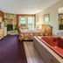 Highland Hills Motel & Cabins in Boone room with stone fireplace, king bed, TV and red whirlpool tub