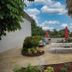 Outdoor patio with picnic tables and umbrellas at Riverwatch Apartments By Lowkl in Jensen Beach
